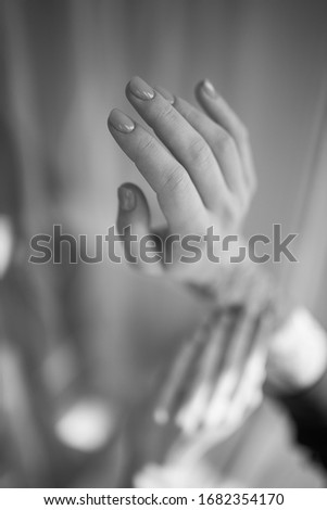 Female hands with a gentle manicure. Tender female hands. Hands. Black and white photo.