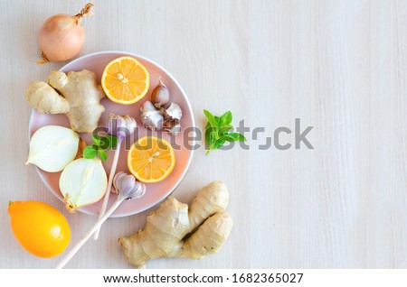 top view of spice set, vegetables garlic, ginger, onions, lemon to boosting immunity, treat colds, viruses, flu on light background, copy space. alternative medicine. soft focus. eco products Royalty-Free Stock Photo #1682365027