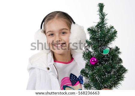 cheerful girl near Christmas tree, decorated glasses. Studio, white background