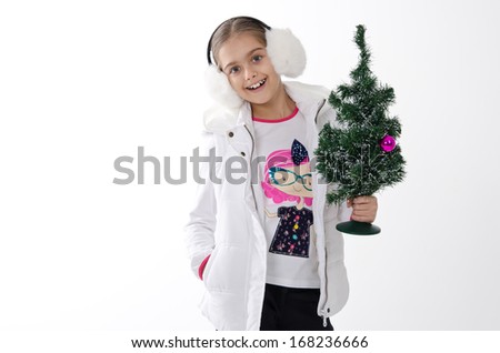 beautiful girl holding a small Christmas tree