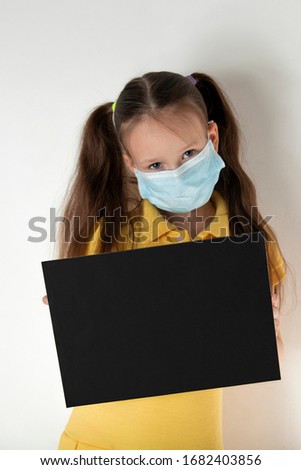 Health care covid-19 epidemic outbreak concept of little girl holding paper black banner with copy space