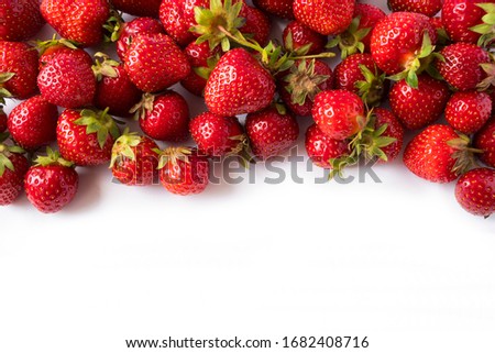 Strawberries on white background. Ripe berries close-up. Strawberries at border of image with copy space. Top view. Background of red berries. Background of fresh strawberries. Various fresh summer.