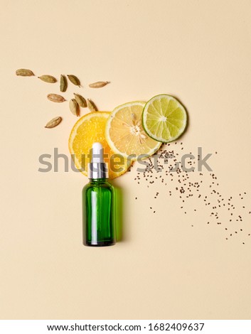 Concept of natural beauty products. Flat lay of serum oil with pipette and citrus vitamin component and fresh ingredients on pastel background Royalty-Free Stock Photo #1682409637