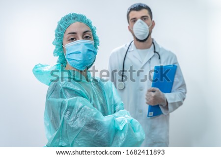 Coronavirus. Thank you doctors and nurses working in the hospitals and fighting the coronavirus. Doctors are heroes. Doctors in the protective suits and masks looking for a cure for the disease.  Royalty-Free Stock Photo #1682411893