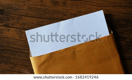 envelope and white card with space, on wooden table.