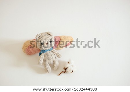 Crochet yarn bear doll on white background