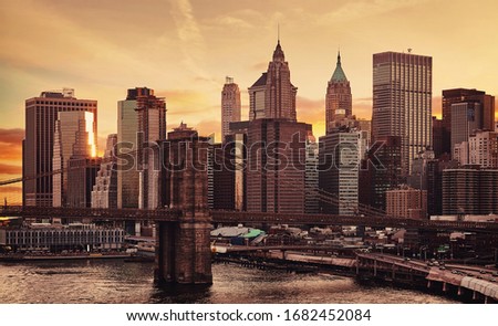 Manhattan and Brooklyn Bridge at sunset, color toning applied, New York City, USA.