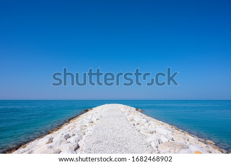 White stones walkway into beautiful sea view over blue sky background, Bahrain