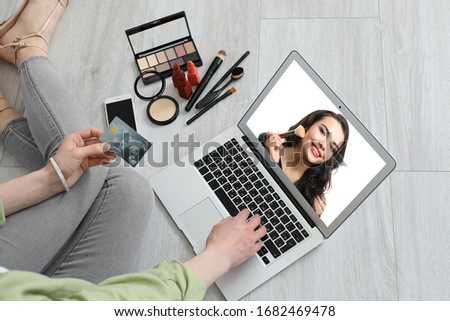 Female makeup artist with laptop at home
