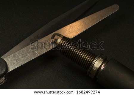 Spark plug and feeler gauge. Internal combustion engine service. Royalty-Free Stock Photo #1682499274