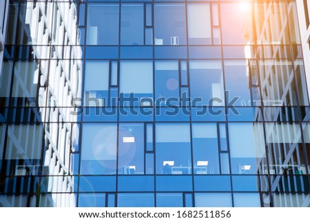 View of office building  with sunrise, reflection and perspective. Bright outlook for business. Modern office block with sunny beautiful sky.