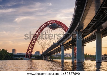 Sunset view of Picturesque bridge with big red arch over the Moscow river, Moscow, Russian Federation. Royalty-Free Stock Photo #1682527690