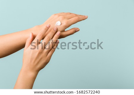 closeup view of woman hands applying hand cream. beauty shot Royalty-Free Stock Photo #1682572240