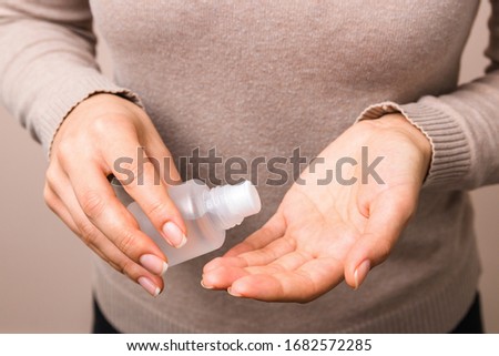 closeup clean woman hands using sanitiser to disinfect her hands. corect hygiene actions