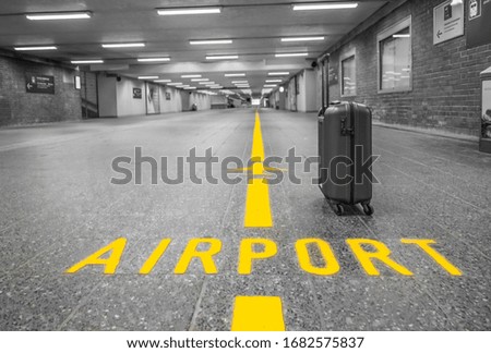 Luggage in an empty pedestrian tunnel to the airport