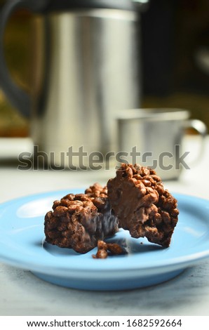 Chocolate bar in blue saucer with coffee