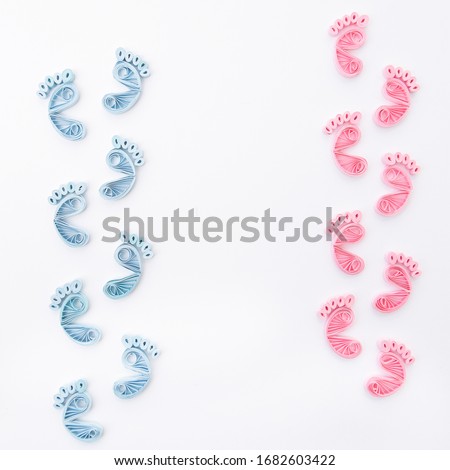Cute baby boys and girls footprints. Traces of children on white background. Baby footsteps. Hand made of paper quilling technique.
