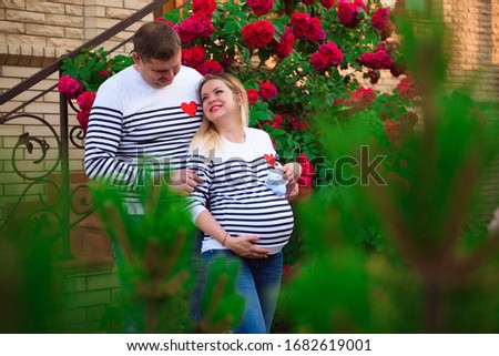 Young pregnant woman with her husband outdoors