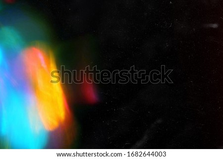 Designed film texture background with heavy grain, dust and a light leak Real Lens Flare Shot in Studio over Black Background. Easy to add as Overlay or Screen Filter over Photos overlay Royalty-Free Stock Photo #1682644003