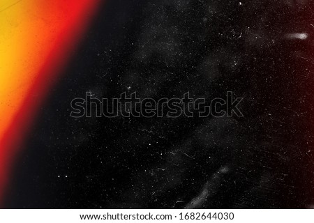 Designed film texture background with heavy grain, dust and a light leak Real Lens Flare Shot in Studio over Black Background. Easy to add as Overlay or Screen Filter over Photos overlay Royalty-Free Stock Photo #1682644030