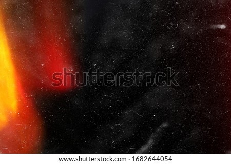 Designed film texture background with heavy grain, dust and a light leak Real Lens Flare Shot in Studio over Black Background. Easy to add as Overlay or Screen Filter over Photos overlay Royalty-Free Stock Photo #1682644054