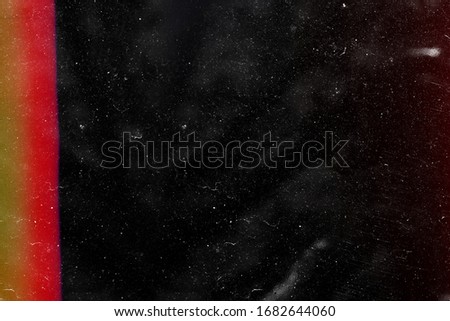 Designed film texture background with heavy grain, dust and a light leak Real Lens Flare Shot in Studio over Black Background. Easy to add as Overlay or Screen Filter over Photos overlay Royalty-Free Stock Photo #1682644060