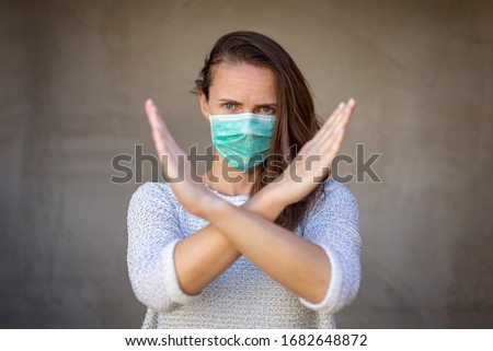 Woman wearing medical face protection mask; air pollution or allergies protection, coronavirus, bacterial and viral respiratory infections prevention and social distancing concept