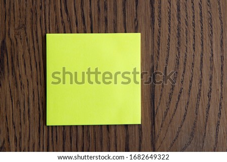 Colorful sticky notes on wooden background.