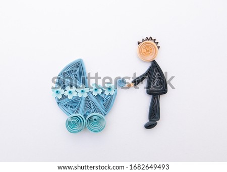 Father with a newborn baby. Parrent with carriage. Hand made of paper quilling technique.
