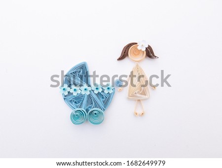 Mother with a newborn baby. Parrent with carriage. Hand made of paper quilling technique.