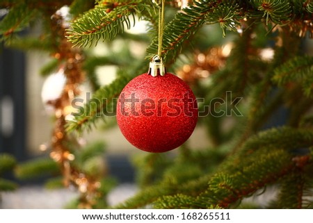 One red Christmas ball on Christmas tree