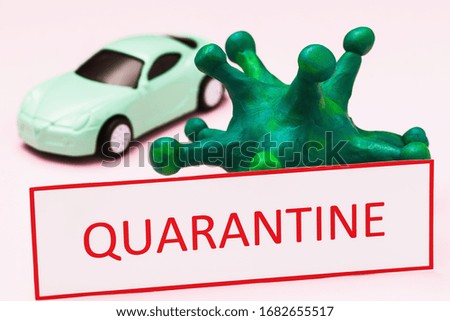 Tag with text, toy car and coronavirus, closeup. Concept on the ban on the movement of cars due to the outbreak of the COVID-19 pandemic