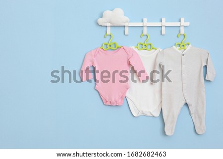 Baby clothes on a hanger. Place for text, minimalism.
