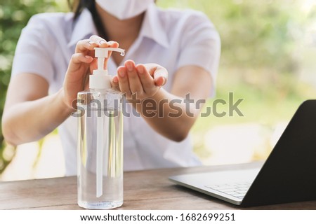 woman using alcohol gel from bottle and applying sanitizer for hand make cleaning virus covid 19