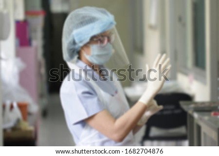Blurred image of Nurse in Level-C Protection, For Protection COVID-19