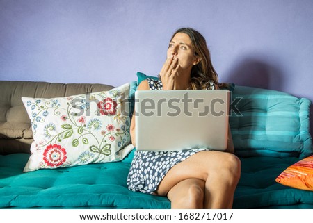 woman at working on her laptop on a sofa
