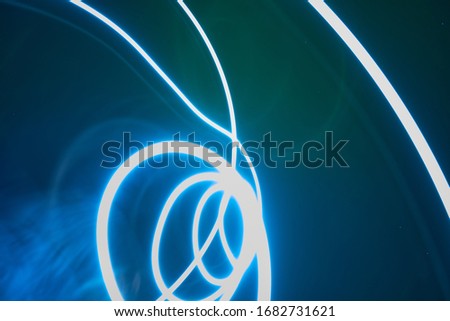 Blue abstract waves:3D rendered fractal. round cylindrical light lines on a blue background of the night sky with stars