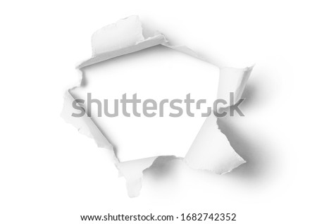 Ragged hole torn in ripped paper, isolated on white background Royalty-Free Stock Photo #1682742352