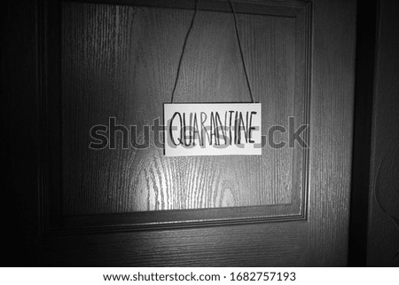 Quarantine plate. The inscription quarantine. Quarantine. Insulation. Self isolation. Black and white photo.