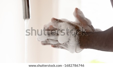 Close up of man wash clean hands with antibacterial soap liquid protect from covid-19 coronavirus outbreak, person take care of body hygiene, stop corona virus pandemic, healthcare concept