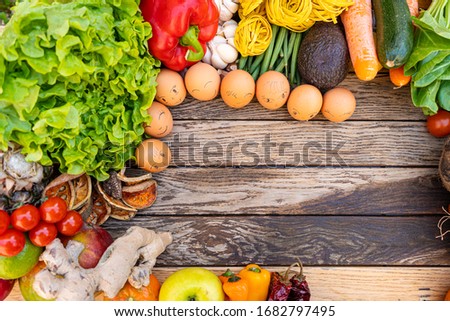 Colorful composition of assorted vegetables: tomato, egg,garlic,lemon,salad,mango,onion,lettuce, Studio photography. No people. Healthy eating concept. Organic and fresh food concept.on  background