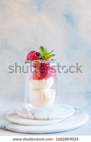 Tasty homemade multicolored popsicles ice cream with mint leaves in a glass cup
