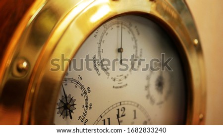 Vintage Nautical Brass Clock with Atmospheric pressure and temperature and weather forecast prediction Royalty-Free Stock Photo #1682833240