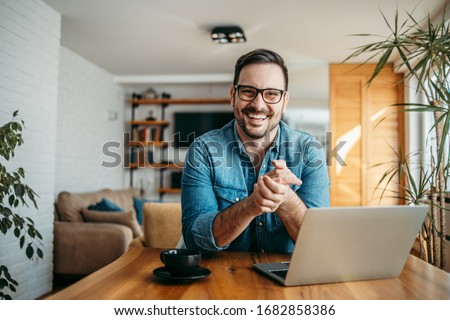 Portrait of a successful entrepreneur at cozy home office, smiling at camera. Royalty-Free Stock Photo #1682858386