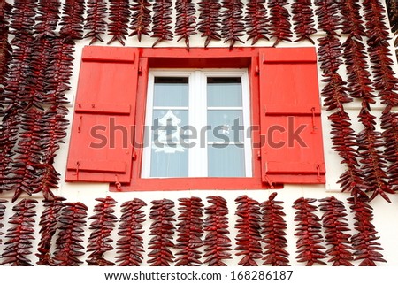 Espelette peppers surrounding the window Royalty-Free Stock Photo #168286187