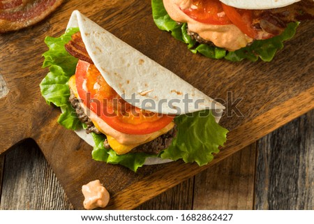 Homemade Cheeseburger Taco in a Tortilla with Lettuce and Tomato