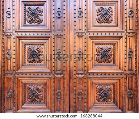 A detail of a wooden gate of Florence's dome in Italy