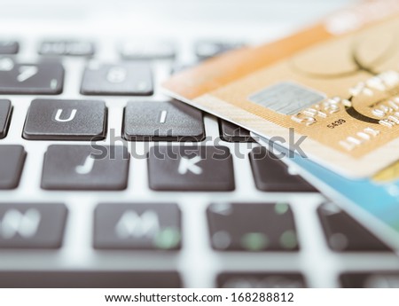 Credit cards laying on a keyboard Royalty-Free Stock Photo #168288812