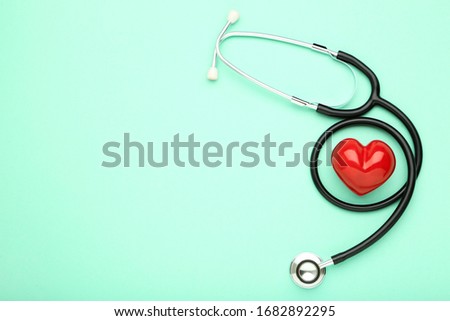 Stethoscope with red heart on mint background