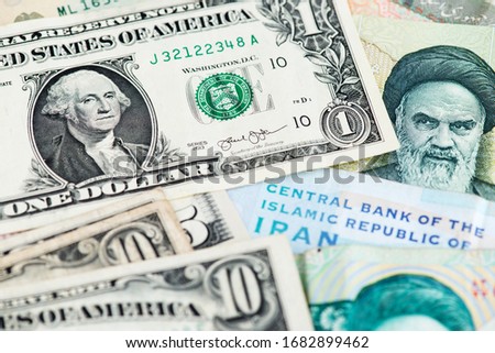 US Dollar and Iran Rial currency banknotes. USA vs IRAN 